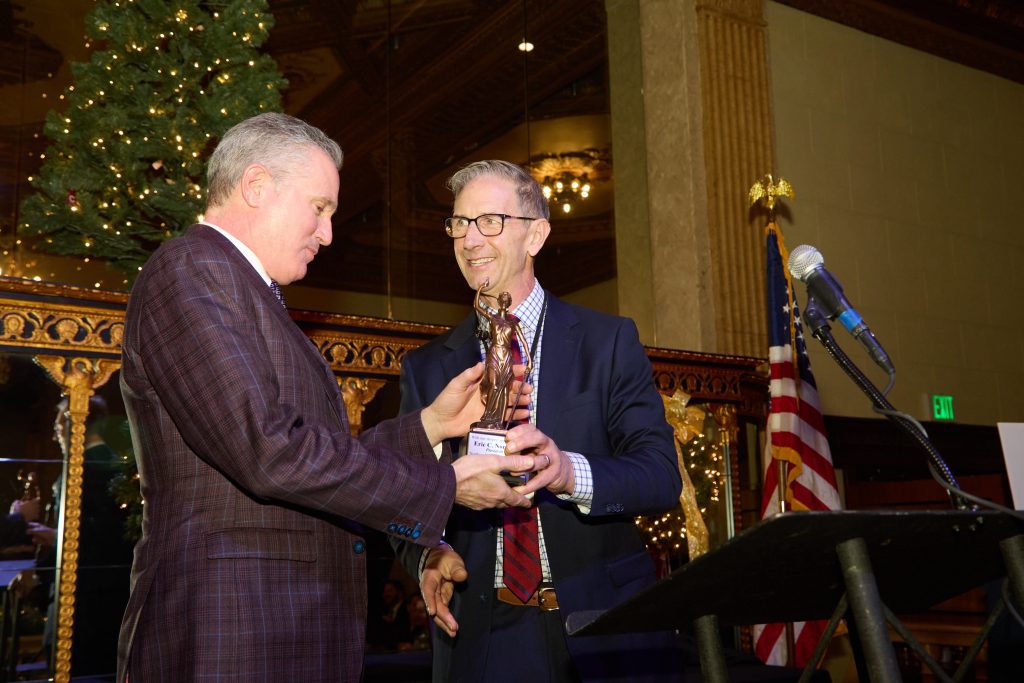 Man presenting another man with award