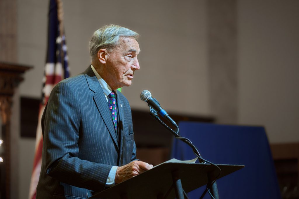 man speaking at podium