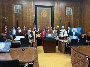 group of people in period costume in courtroom